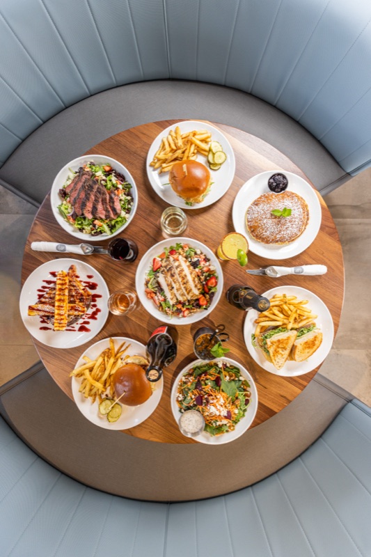 A round booth table full of plates from above