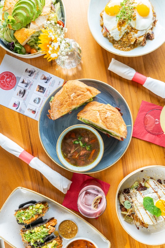 A brunch spread with eggs, sandwiches and soup