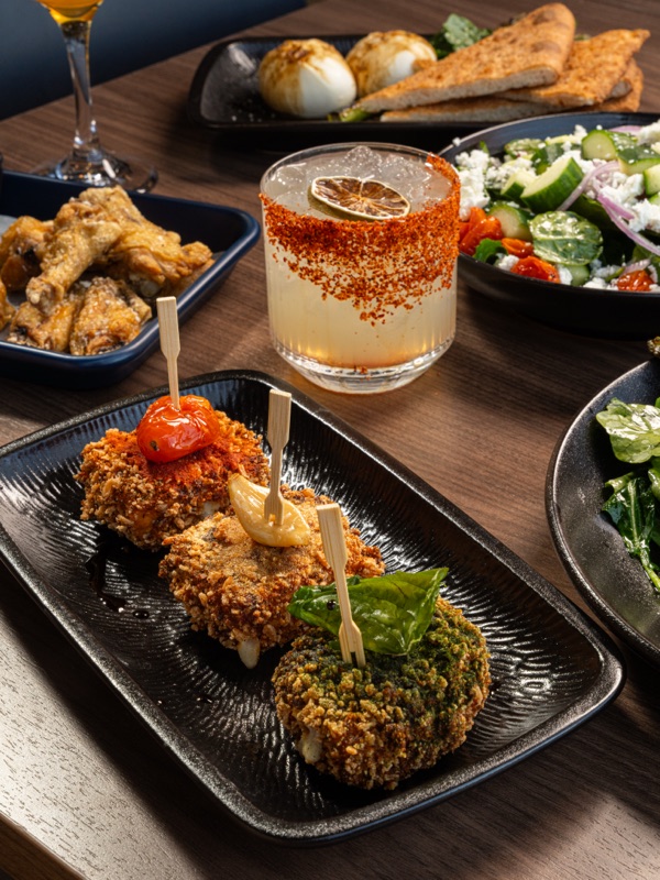Appetizers and a cocktail on a restaurant table