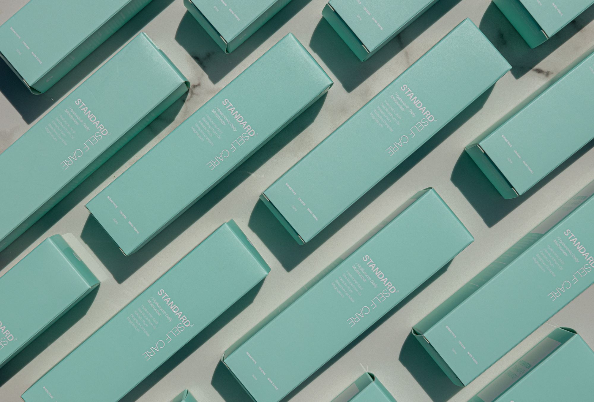 Teal product boxes shot flat from above